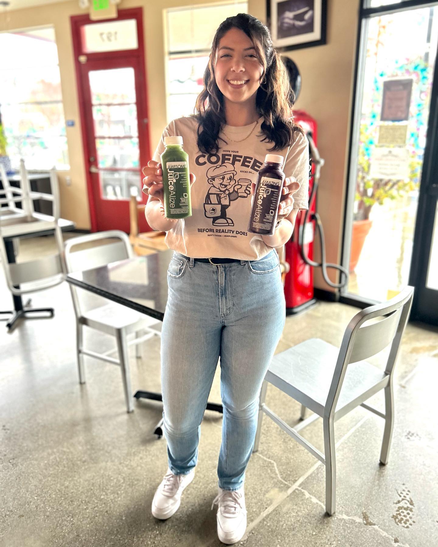 Barista holding AWESOME and AMAZING juices at Roy's Station